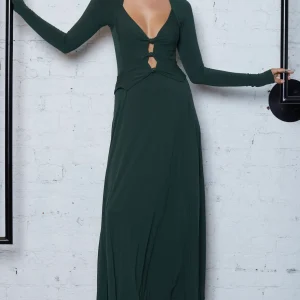 woman wearing a cut out green long dress with brown boots