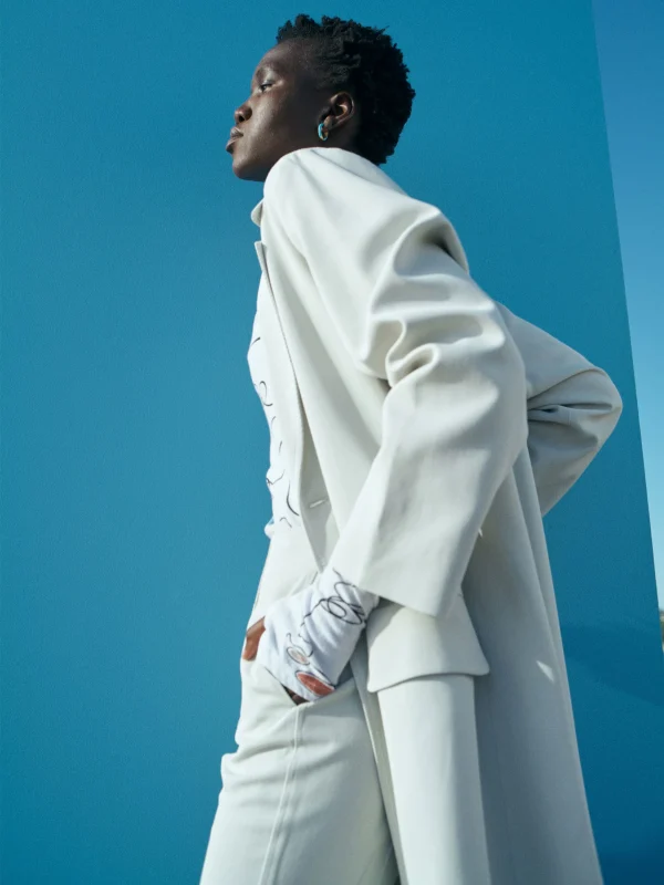 black woman wearing a tailored whit set